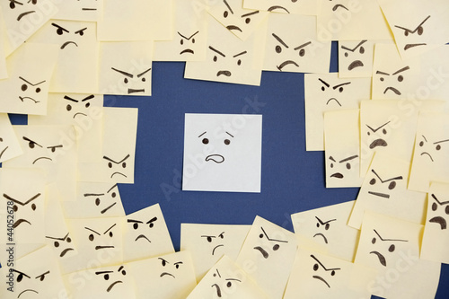 Photo: Sticky notes with anthropomorphic face blaming colleague Sticky notes with anthropomorphic face blaming colleague