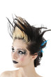 Close-up of gothic woman with face painting and spiked hair over white background