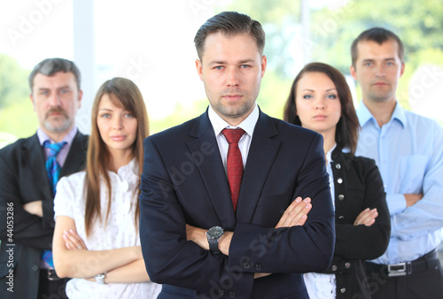 Photo: Professional business team looking confidently at camera Professional business team looking confidently at camera