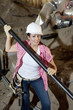 Portrait of young construction worker holding pipe