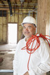 Portrait of a construction worker with a red electric wire