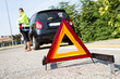Photo: Broken down car with red warning triangle Broken down car with red warning triangle