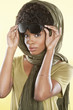 Foto: Portrait of an African American woman holding sunglasses with a stole over her head Portrait of an African American woman holding sunglasses with a stole over her head