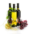 bottles and glasses of wine and ripe grapes isolated on white