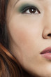 Cropped image of beautiful Chinese woman with makeup looking away