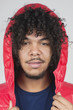 Portrait of young man with hooded jacket over colored background