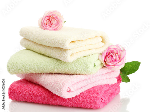 Photo: bright towels and roses isolated on white bright towels and roses isolated on white