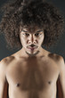 Portrait of shirtless young man with curly hair