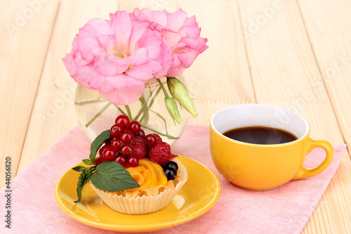 Photo: Dulcet cake with fruit and berries on wooden table Dulcet cake with fruit and berries on wooden table