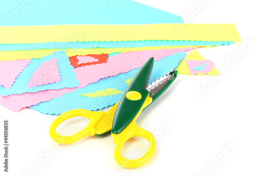 Photo: Colorful zigzag scissors with color paper isolated on white Colorful zigzag scissors with color paper isolated on white