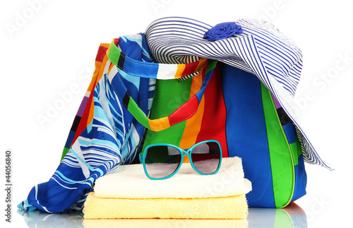 Photo: Beach bag with accessories isolated on white Beach bag with accessories isolated on white