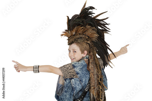 Photo: Portrait of boy in costume with headdress looking back over white background Portrait of boy in costume with headdress looking back over white background