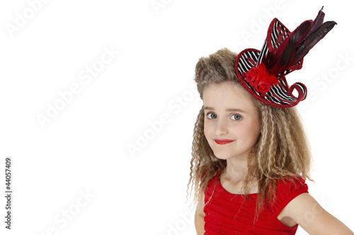 Photo: Portrait of school girl wearing headgear over white background Portrait of school girl wearing headgear over white background