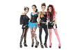 Portrait of all female rock band posing together over white background