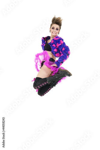 Photo: Happy young punk woman jumping over white background Happy young punk woman jumping over white background