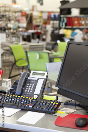 Photo: Computer with landline phone in store counter Computer with landline phone in store counter