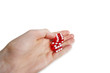Cropped image of hands holding gambling cubes over white background