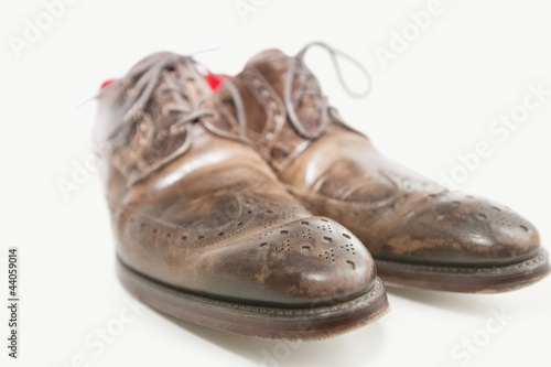 Photo: Close-up of men's leather shoe over white background Close-up of men's leather shoe over white background