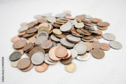 Photo: Close-up of large group of coins over white background Close-up of large group of coins over white background