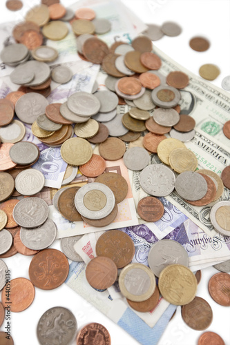 Photo: Close-up of paper currencies and coins Close-up of paper currencies and coins