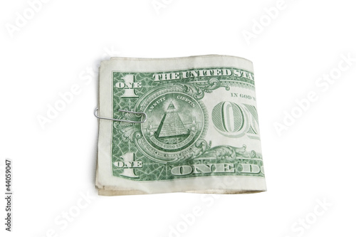 Photo: Close-up of paper dollars in clip over white background Close-up of paper dollars in clip over white background