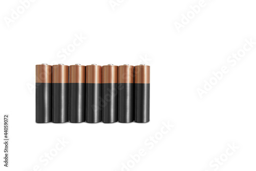 Photo: Close-up of batteries in a row over white background Close-up of batteries in a row over white background