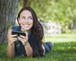 Mixed Race Young Female Texting on Cell Phone Outside
