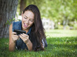 Photo: Mixed Race Young Female Texting on Cell Phone Outside Mixed Race Young Female Texting on Cell Phone Outside