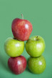 Photo: Pile of red and green apples over colored background Pile of red and green apples over colored background
