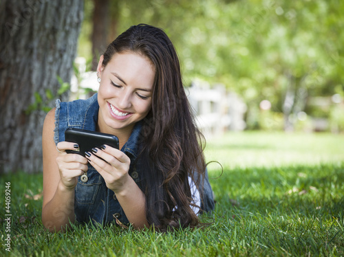 Photo: Mixed Race Young Female Texting on Cell Phone Outside Mixed Race Young Female Texting on Cell Phone Outside
