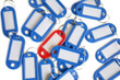 Red tag ring with blue key rings over colored background