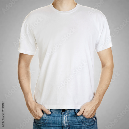 Photo: White t-shirt on a young man template on gray background White t-shirt on a young man template on gray background