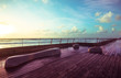 Stone benches and wooden deck besprinkled with sea water