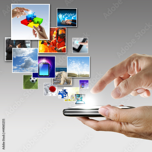 Photo: hand holds touch screen mobile phone streaming images hand holds touch screen mobile phone streaming images