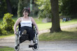 Woman  in wheelchair outdoors in the park