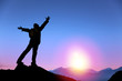 young man standing on the top of mountain