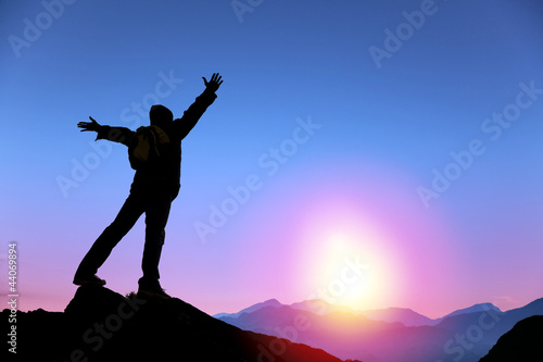 Photo: young man standing on the top of mountain young man standing on the top of mountain