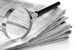 daily newspaper and a magnifying glass to find news