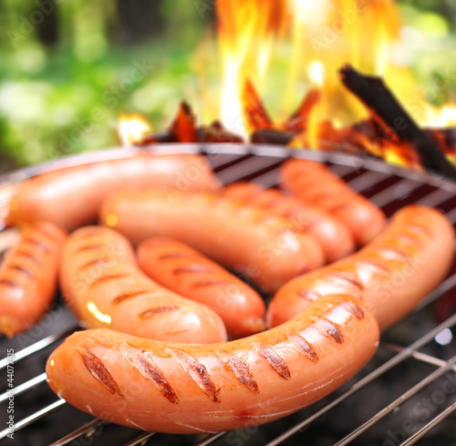 Photo: Sausages on a grill. Sausages on a grill.