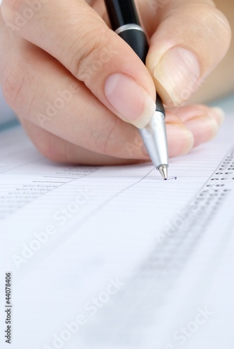 Photo: ballpoint pen in a female hand ballpoint pen in a female hand