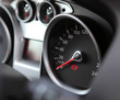 Car dashboard : An illuminated car dashboard in red and black