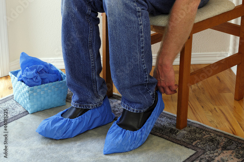 Photo: Person Putting on Booties Person Putting on Booties