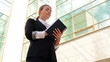 businesswoman making notes near the office building