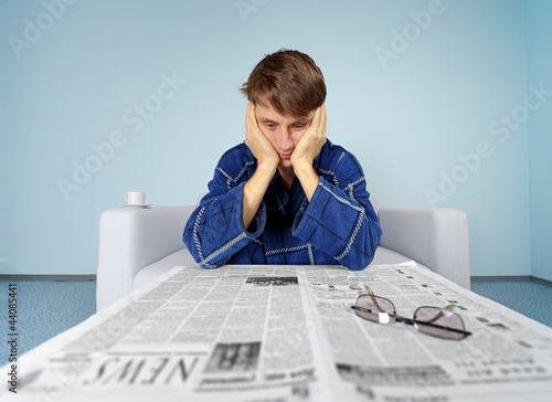 Photo: Man with newspaper - hard find a job Man with newspaper - hard find a job