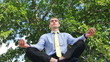 Video: Young businessman doing yoga in the park Young businessman doing yoga in the park