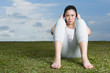 Chinese woman doing situps in park.