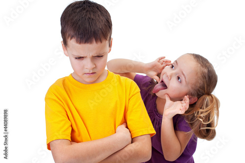Photo: Young girl mocking boy - isolated Young girl mocking boy - isolated