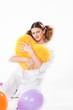 girl keeps a yellow pillow in a pajamas in the form of heart
