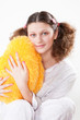 girl keeps a yellow pillow in a pajamas in the form of heart