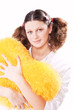 girl keeps a yellow pillow in a pajamas in the form of heart